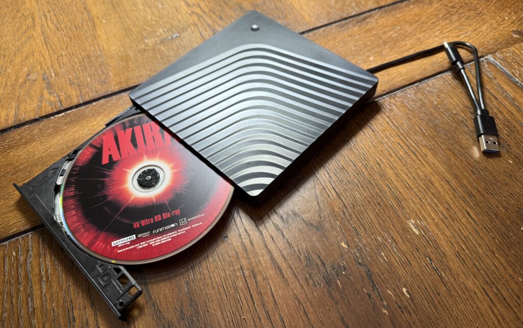 A snazzy photo of the drive with an Akira UHD disc inside of it