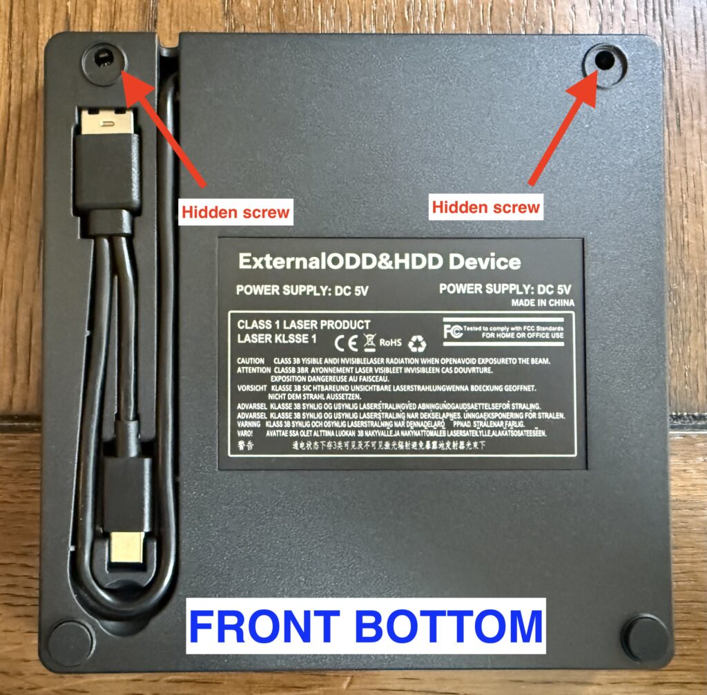 a view of the enclosure, upside-down, with the rear 2 feet removed, exposing screws