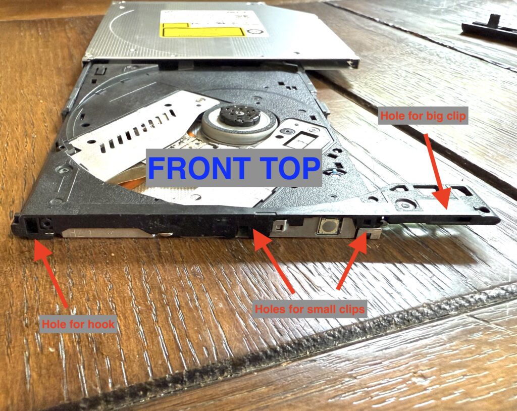 a front-on view of the disk tray, showing the locations of 4 clips